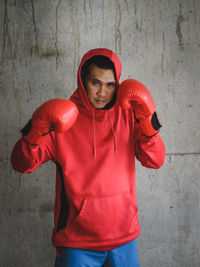 Portrait of male boxer against wall