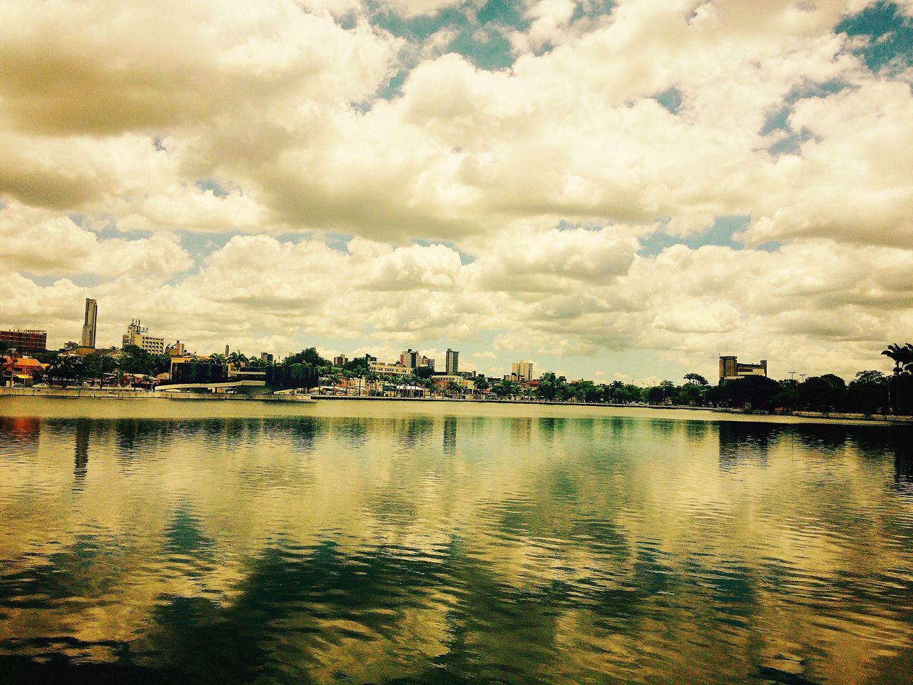 water, sky, cloud - sky, cloudy, waterfront, sea, built structure, building exterior, weather, architecture, cloud, tranquility, overcast, nature, reflection, river, scenics, tranquil scene, dusk, beauty in nature