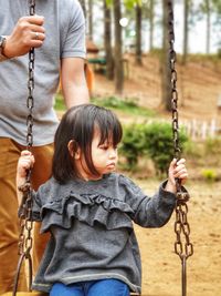 Full length of a boy on swing at playground