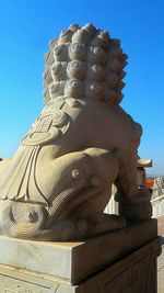 Low angle view of temple against clear blue sky