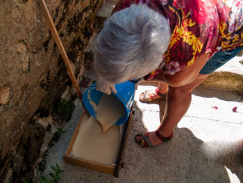 Woman recycling soap outdoors