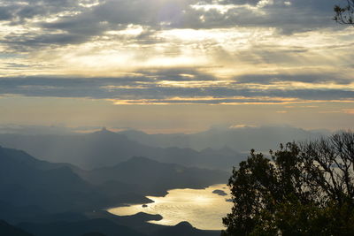 Scenic view of mountains against sky at sunset