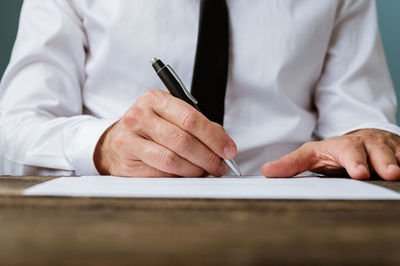 Midsection of man working on table