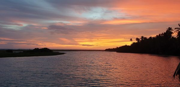 Scenic view of sea against orange sky