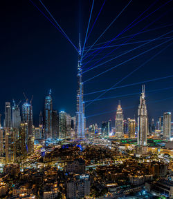 Illuminated cityscape against sky at night