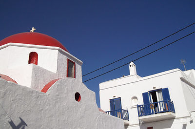 Low angle view of building against clear blue sky - detail of church in mykonos