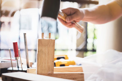 Close-up of man holding ice cream on table