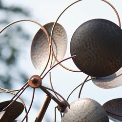 Low angle view of metal art against sky