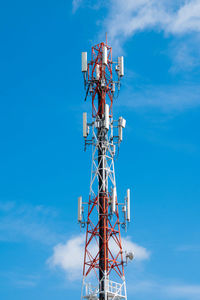 Low angle view of communications tower against blue sky