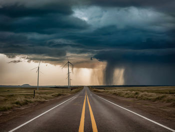 Empty road against cloudy sky