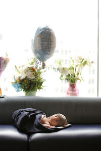 Rear view of man relaxing on floor at home