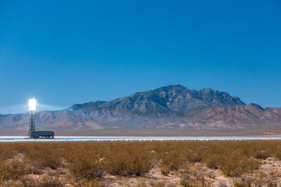 Scenic view of mountain against blue sky