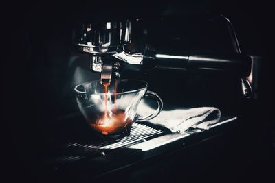 Close-up of coffee pouring in cup