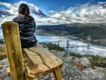 Silhouette of woman standing on mountain against sky