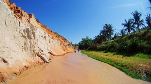 Scenic view of sand dunes against clear sky