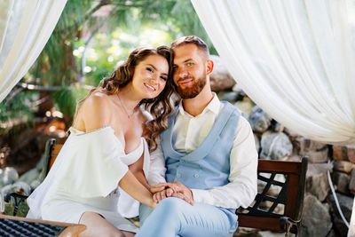 Young couple sitting outdoors