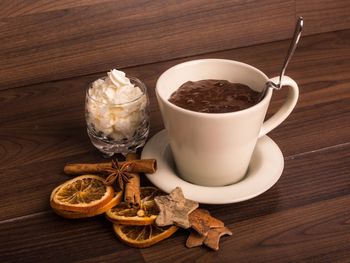 Close-up of hot chocolate with cream and spices on table