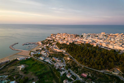 High angle view of buildings and sea against sky