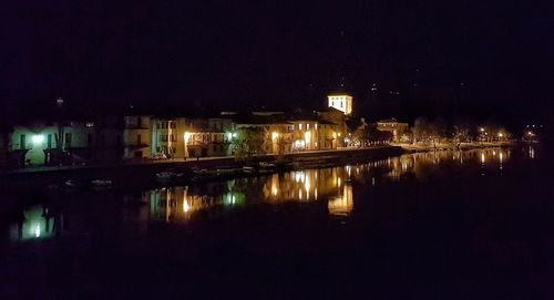 Reflection of illuminated buildings in water at night