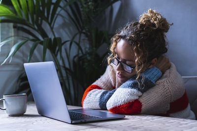 Young woman using laptop at home