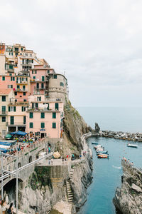 High angle view of townscape by sea against sky