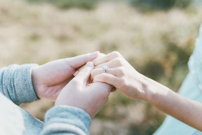 Close-up of couple holding hands