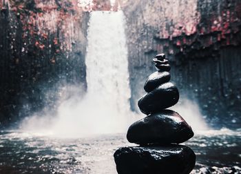 Fountain against waterfall