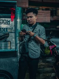 Portrait of young man using mobile phone