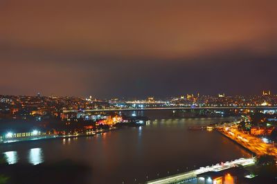 High angle view of illuminated buildings against sky at night