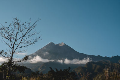 Mount merapi with a blue sky background is located in yogyakarta, indonesia