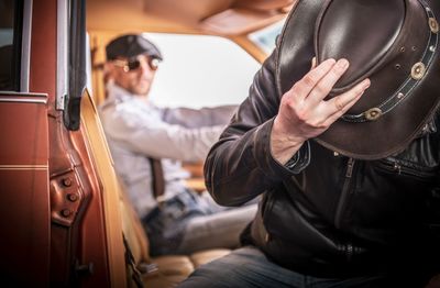 Midsection of man sitting in bus