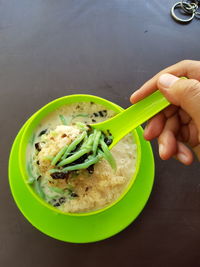 Close-up of hand holding soup in bowl