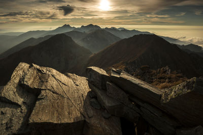 Scenic view of silhouette mountains against sky during sunset