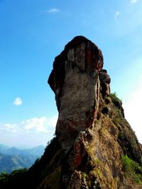 Scenic view of mountains against cloudy sky