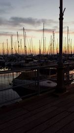 Boats at harbor during sunset