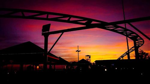 Low angle view of built structure at sunset