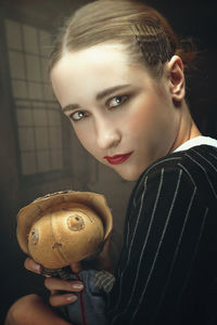 Portrait of a smiling young woman holding ice cream