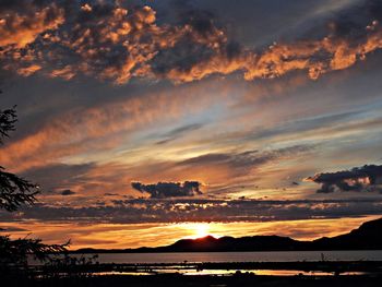 Scenic view of dramatic sky over sea during sunset