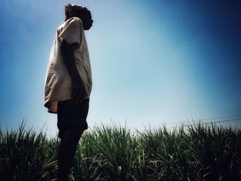 Rear view of man walking on field