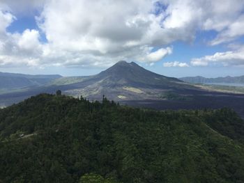 Scenic view of mountains against cloudy sky