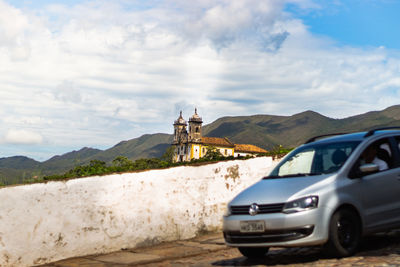 Vintage car on land against mountains