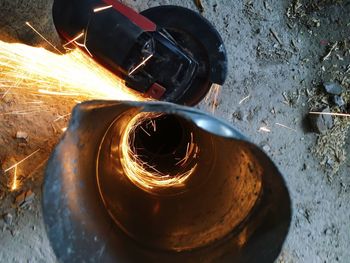 Circular saw cutting metallic pipe at workshop