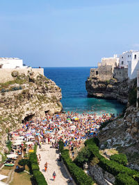 High angle view of townscape by sea against clear sky