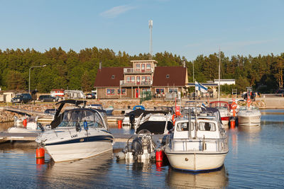 Boats moored in river against sky