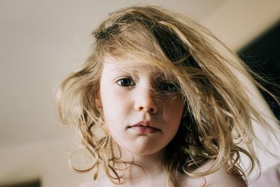 Candid portrait of young girl with bed head hair in the morning