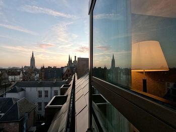 High angle view of modern buildings against sky during sunset