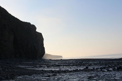 Scenic view of sea against clear sky during sunset