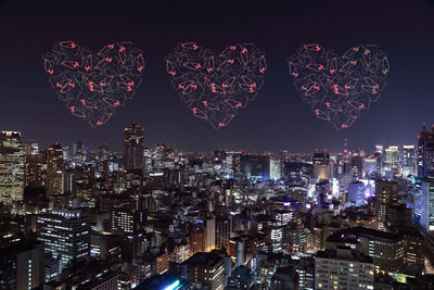 Illuminated city buildings at night