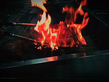 Close-up of meat roasted in fire on barbecue grill