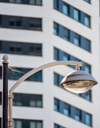 Low angle view of street light against building